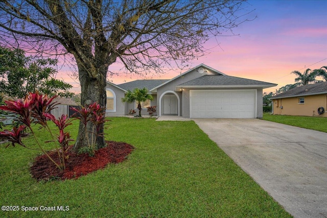 ranch-style home featuring a garage and a lawn