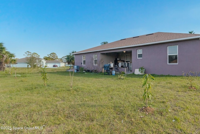 back of house featuring a yard