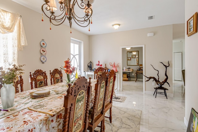 dining room with a notable chandelier