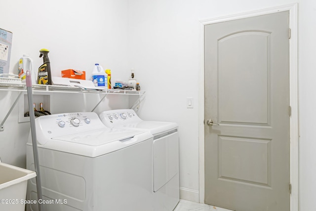 washroom with sink and washing machine and dryer