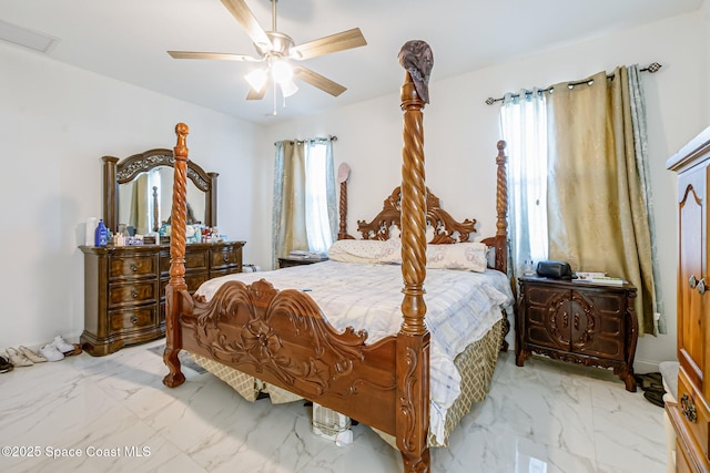 bedroom with ceiling fan and multiple windows