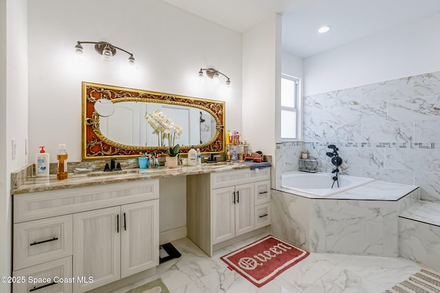 bathroom featuring vanity and tiled bath