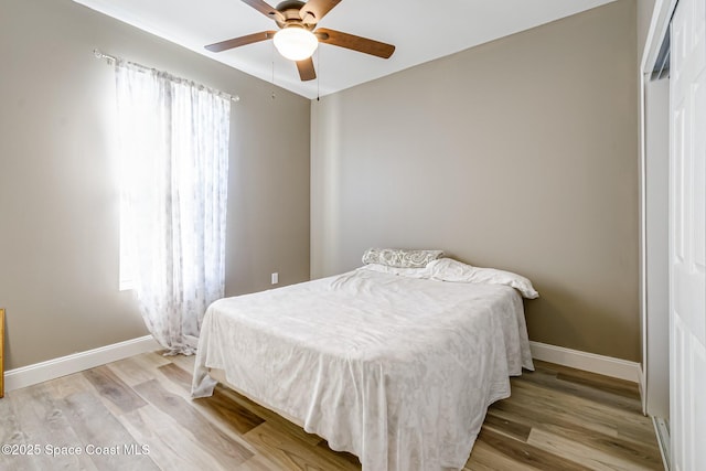 bedroom with ceiling fan and light hardwood / wood-style flooring