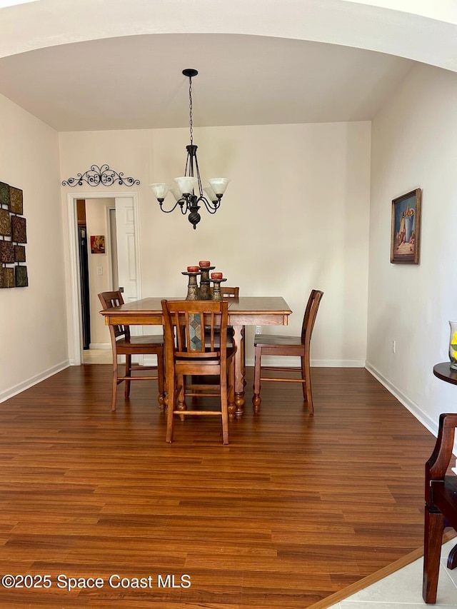 dining space featuring an inviting chandelier and dark hardwood / wood-style floors