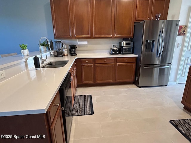 kitchen with sink, kitchen peninsula, dishwasher, and stainless steel refrigerator with ice dispenser