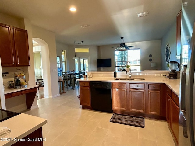 kitchen with pendant lighting, dishwasher, sink, ceiling fan, and stainless steel refrigerator with ice dispenser