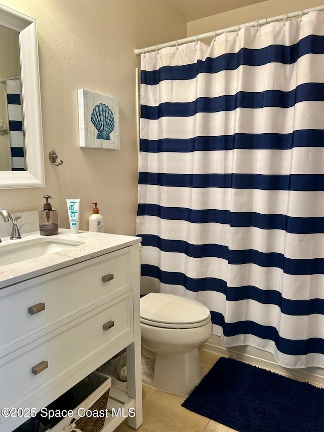 bathroom featuring vanity, tile patterned floors, toilet, and a shower with shower curtain