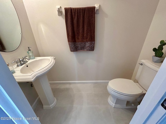 bathroom featuring toilet and tile patterned flooring