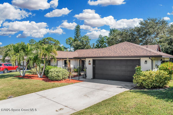 single story home with a garage and a front yard