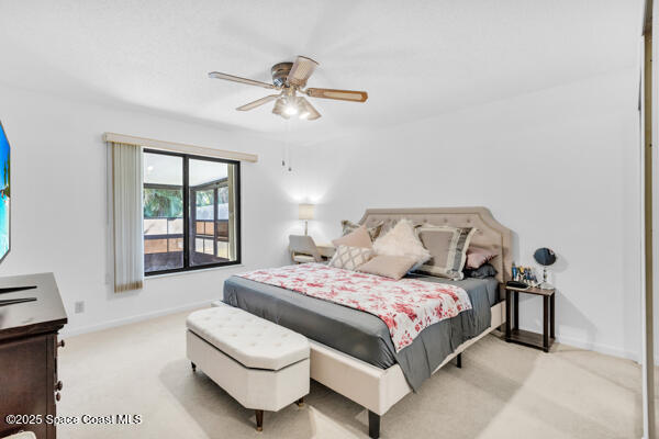 carpeted bedroom with ceiling fan