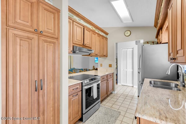 kitchen featuring stainless steel range with electric stovetop, sink, light tile patterned floors, and vaulted ceiling