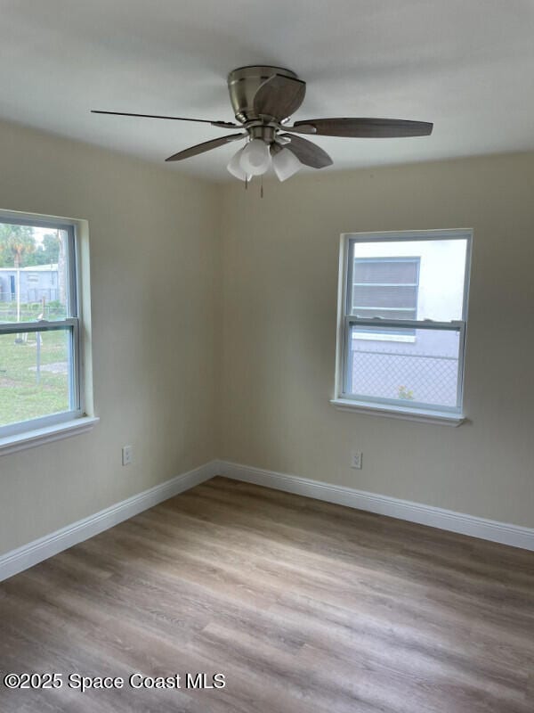 spare room with ceiling fan and light hardwood / wood-style floors