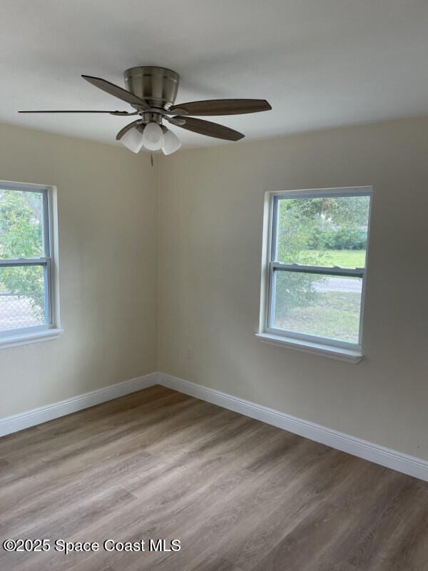 spare room with ceiling fan and light hardwood / wood-style flooring