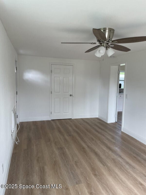 unfurnished room with hardwood / wood-style flooring and ceiling fan