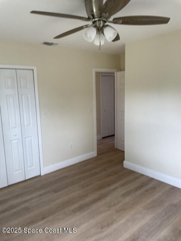 unfurnished room featuring hardwood / wood-style flooring and ceiling fan