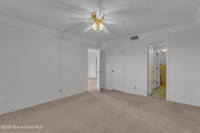 unfurnished room featuring light carpet, ceiling fan, and a textured ceiling