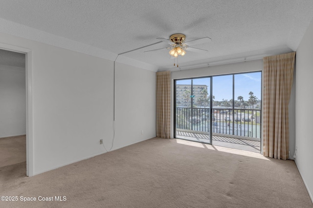 carpeted empty room with a water view, ceiling fan, and a textured ceiling