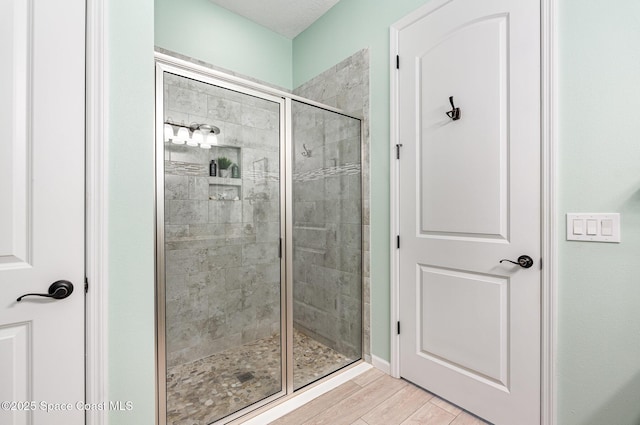 bathroom with wood-type flooring and walk in shower