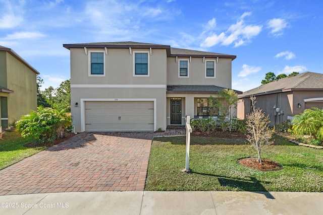 front of property with a garage and a front lawn