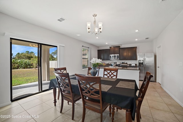 dining area with a notable chandelier and light tile patterned floors