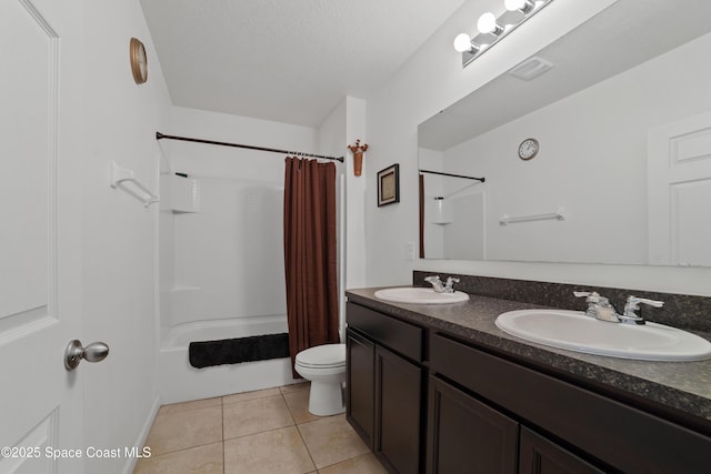 full bathroom with shower / bath combination with curtain, tile patterned flooring, vanity, toilet, and a textured ceiling