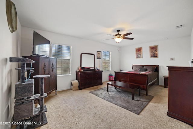 bedroom with ceiling fan and light colored carpet