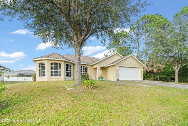 single story home featuring a garage and a front yard