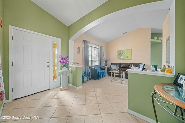 tiled foyer entrance with lofted ceiling