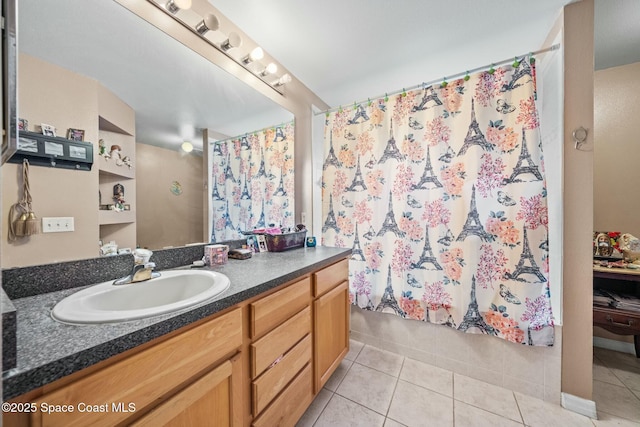 bathroom with tile patterned flooring, shower / bath combo, and vanity