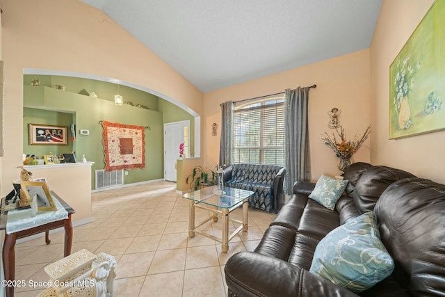 tiled living room featuring vaulted ceiling