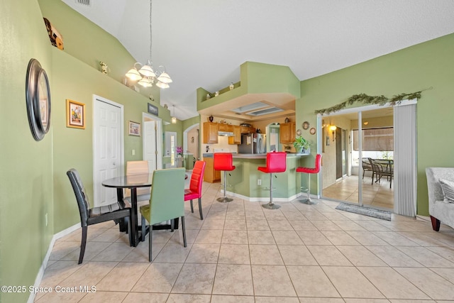 dining room featuring an inviting chandelier and light tile patterned floors