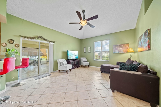 living room with light tile patterned flooring, lofted ceiling, a textured ceiling, and ceiling fan