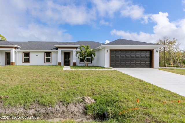 view of front of home with a garage and a front yard