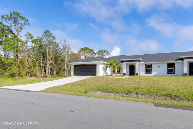 view of front facade with a garage and a front lawn