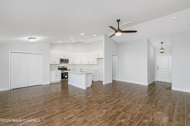 unfurnished living room featuring vaulted ceiling, dark wood-type flooring, sink, and ceiling fan