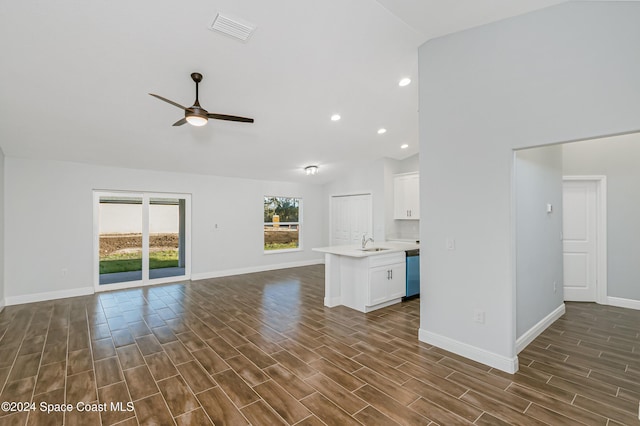 unfurnished living room with high vaulted ceiling, sink, dark wood-type flooring, and ceiling fan