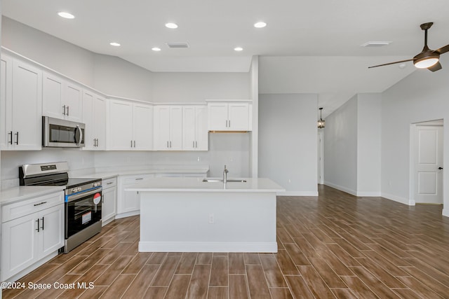 kitchen featuring a center island with sink, white cabinets, and appliances with stainless steel finishes