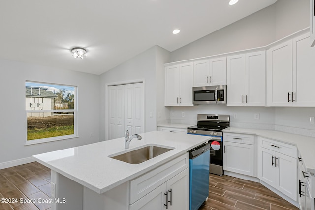 kitchen featuring white cabinetry, appliances with stainless steel finishes, a kitchen island with sink, and sink