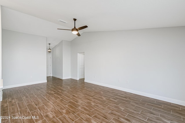 unfurnished room featuring ceiling fan, dark hardwood / wood-style flooring, and vaulted ceiling