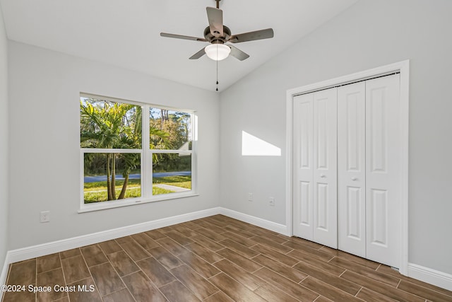 unfurnished bedroom featuring lofted ceiling, ceiling fan, and a closet