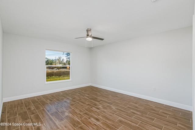 empty room with dark wood-type flooring and ceiling fan