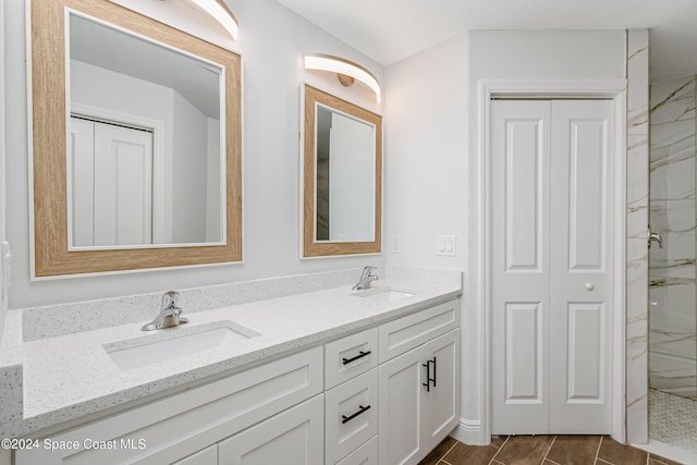 bathroom featuring vanity and an enclosed shower