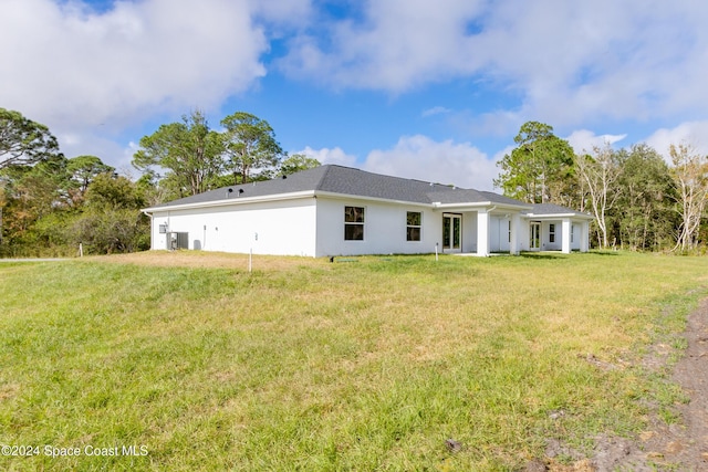 rear view of property with a lawn