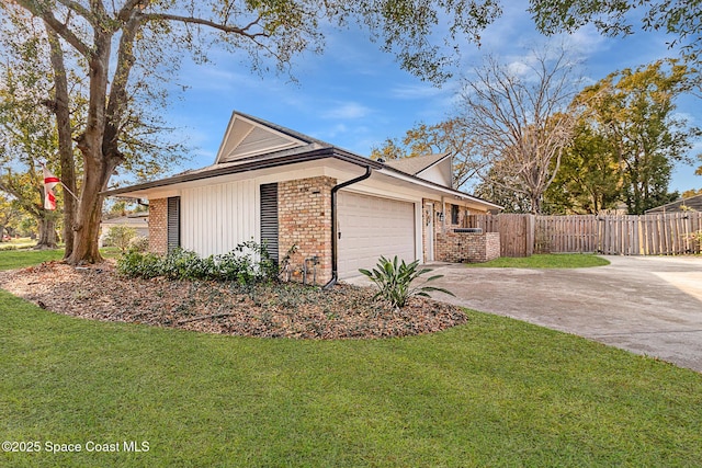 view of side of property with a garage and a lawn