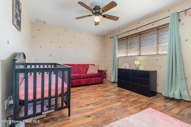 bedroom with ceiling fan and hardwood / wood-style floors