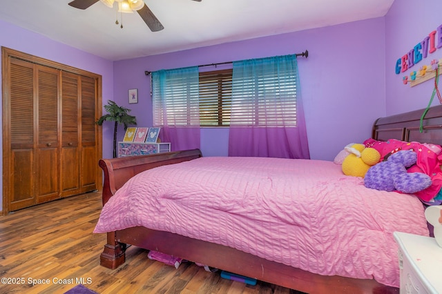 bedroom with wood-type flooring, a closet, and ceiling fan