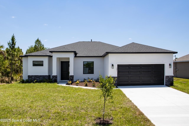 prairie-style home with a garage and a front lawn