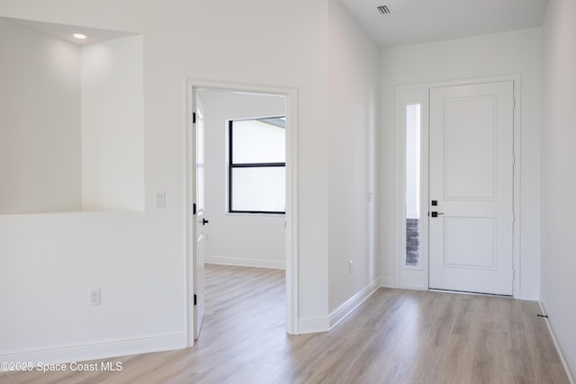 foyer entrance with light hardwood / wood-style flooring