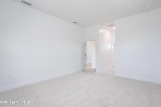 unfurnished room with light carpet