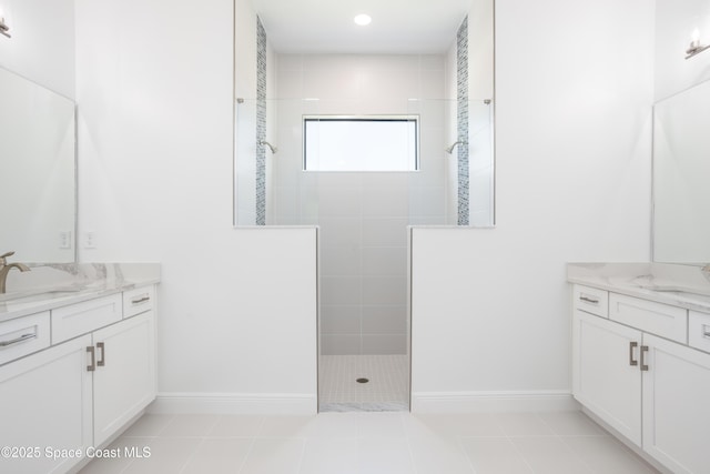 bathroom featuring tiled shower, vanity, and tile patterned floors